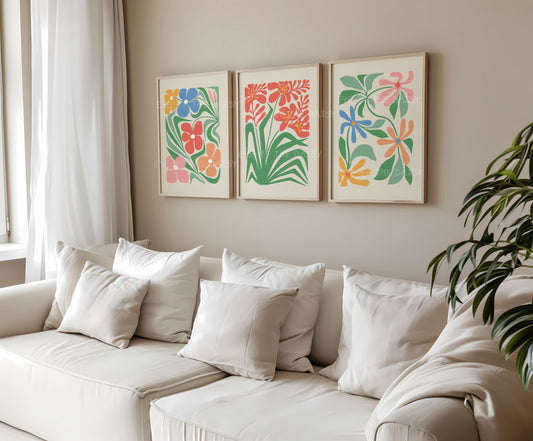 Set of 3 trendy boho abstract floral prints in bright colours with stylized intertwining flowers in a living room