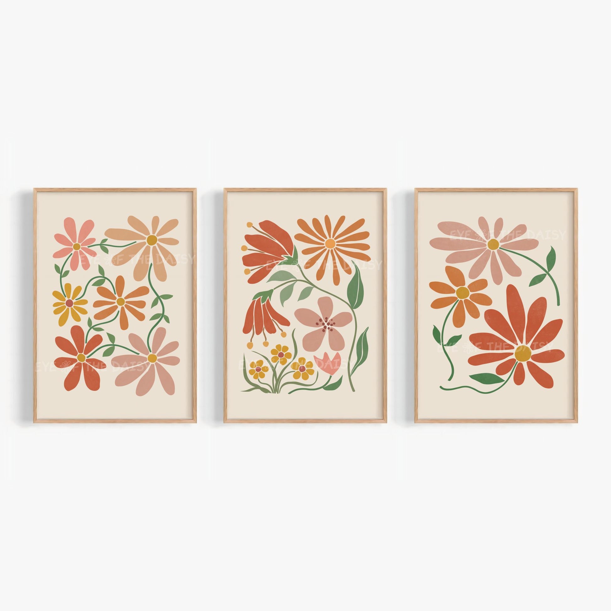 Set of three trendy boho floral wall art prints in terracotta, burnt orange and warm earthy tones on beige