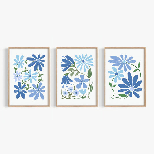 Set of three abstract floral art prints of stylized flowers in different shades of blue on a white background