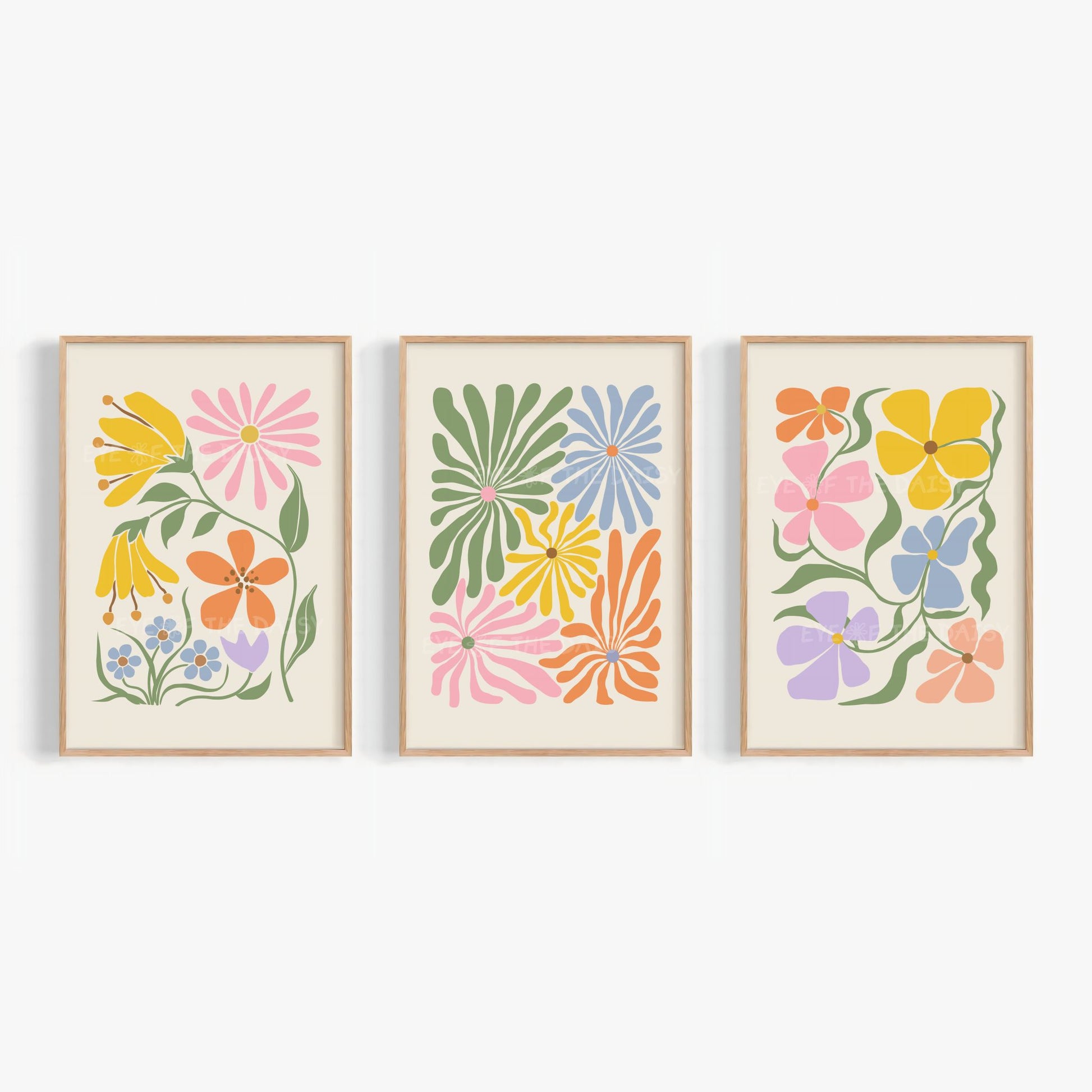 A set of three vibrant botanical abstract digital prints with colorful retro abstract flower cut-outs in pink, mustard yellow, green, lilac, peach, blue and orange on a light beige background