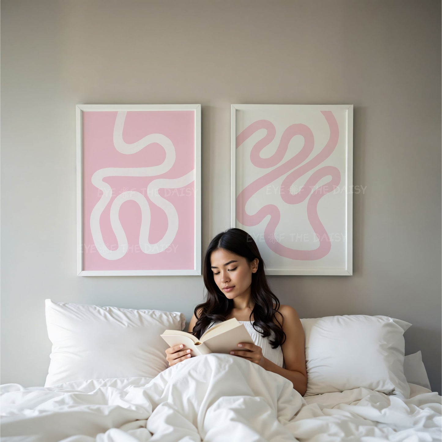 Set of 2 pastel pink and white modern art prints displayed on the wall in a minimal contemporary bedroom