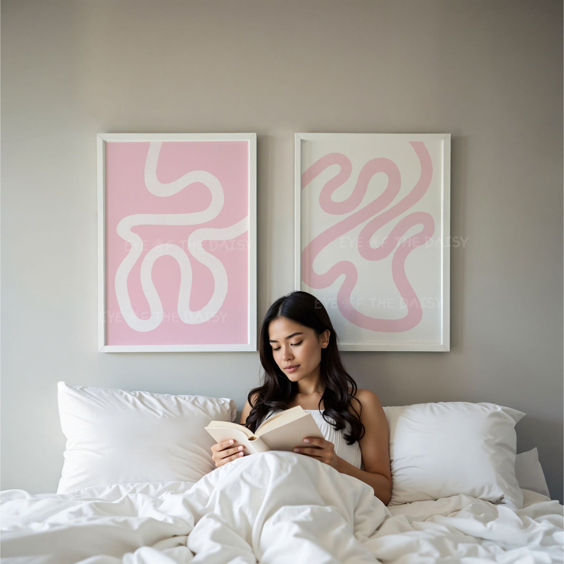 Set of 2 pastel pink and white modern art prints displayed on the wall in a minimal contemporary bedroom