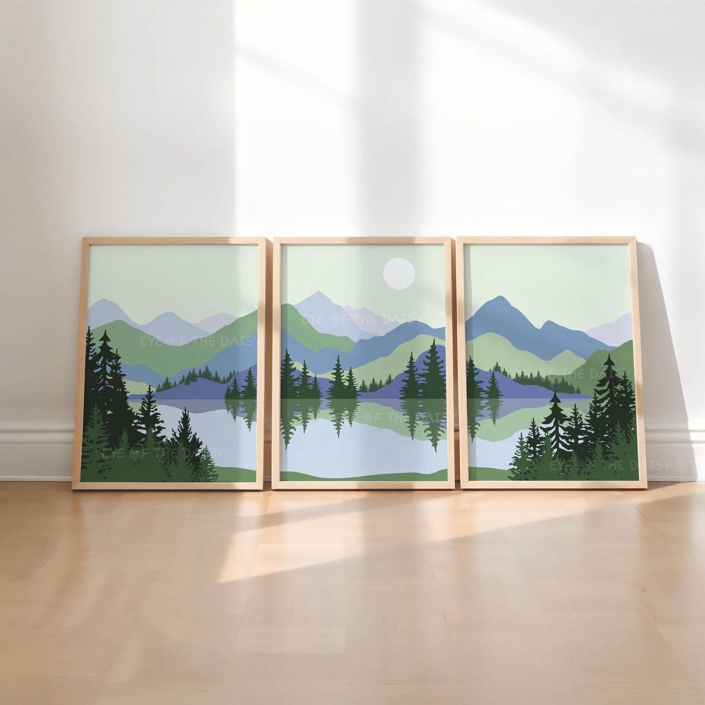 Three piece wall art set of a sage green & navy blue continuous mountain landscape scene with lake and trees in a mid century modern, minimal style