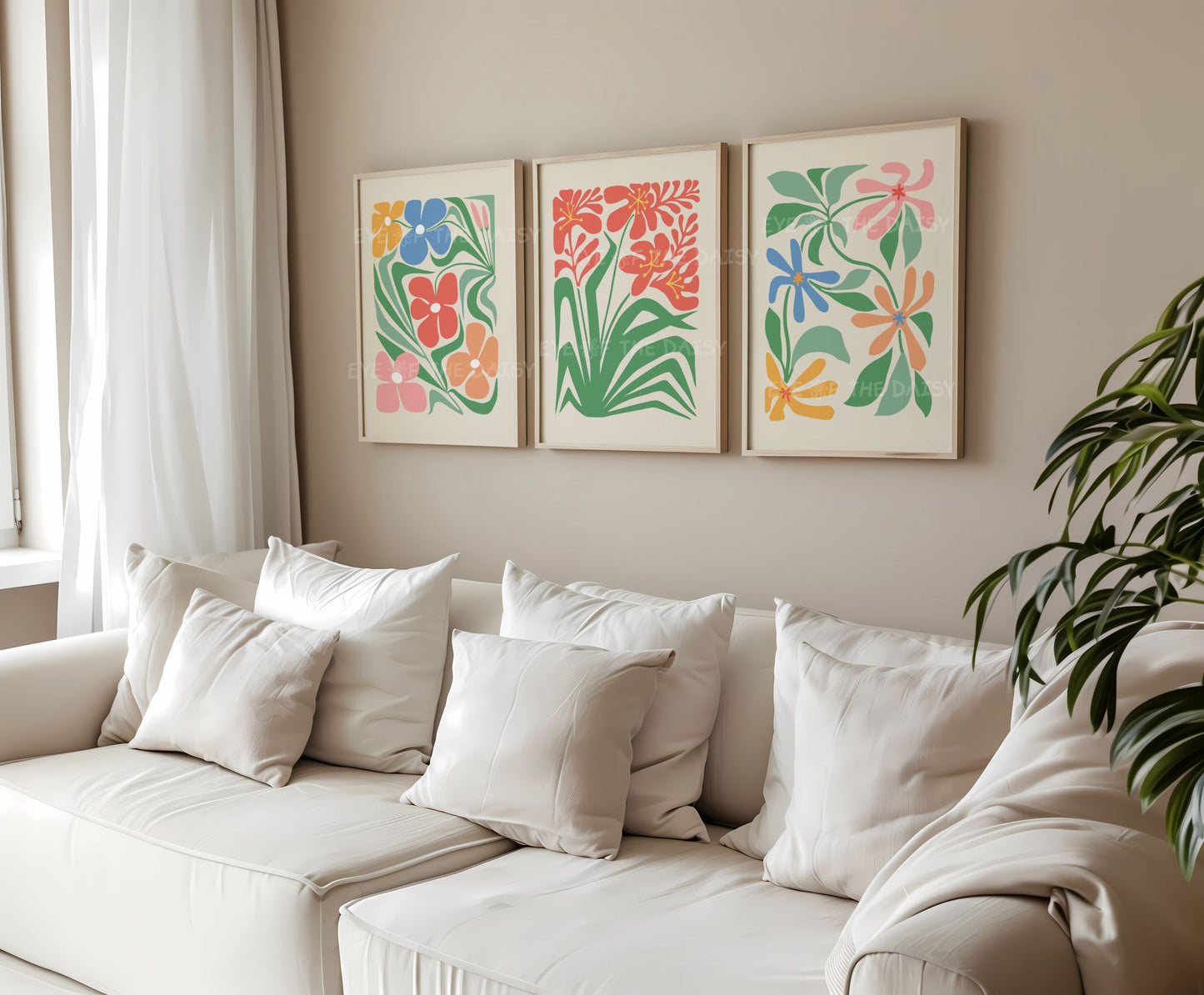Set of 3 trendy boho abstract floral prints in bright colours with stylized intertwining flowers in a living room