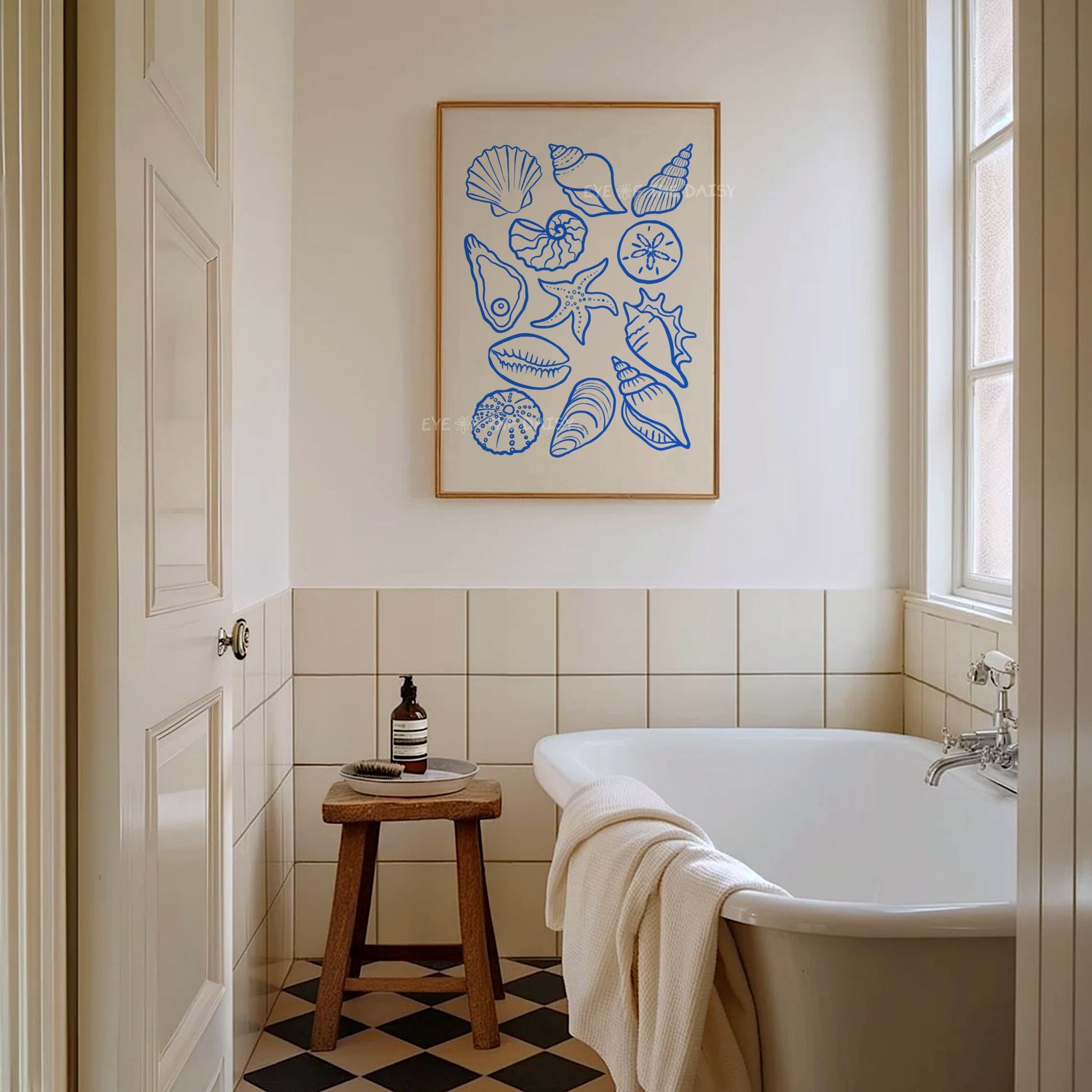 Blue hand drawn sea shells downloadable art print displayed in a modern coastal style bathroom