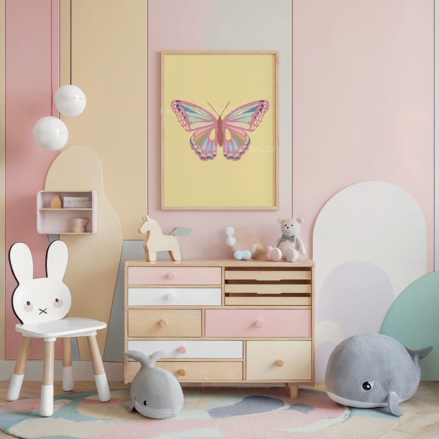 A pastel yellow butterfly print displayed on the wall of a pastel children's room or nursery