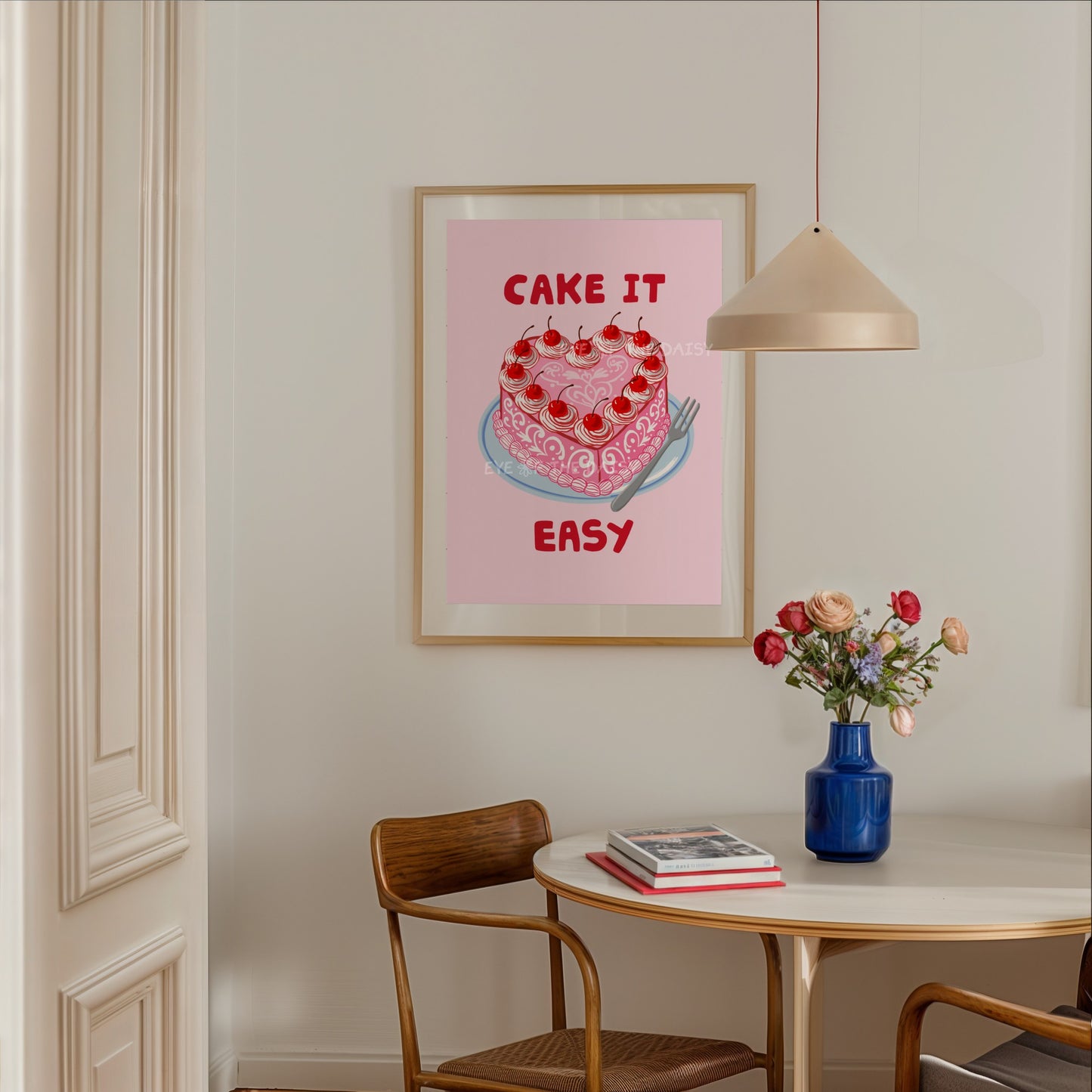 Downloadable poster of a hand drawn trendy heart cake and "Cake it Easy" quote in pink and red, in a cute apartment