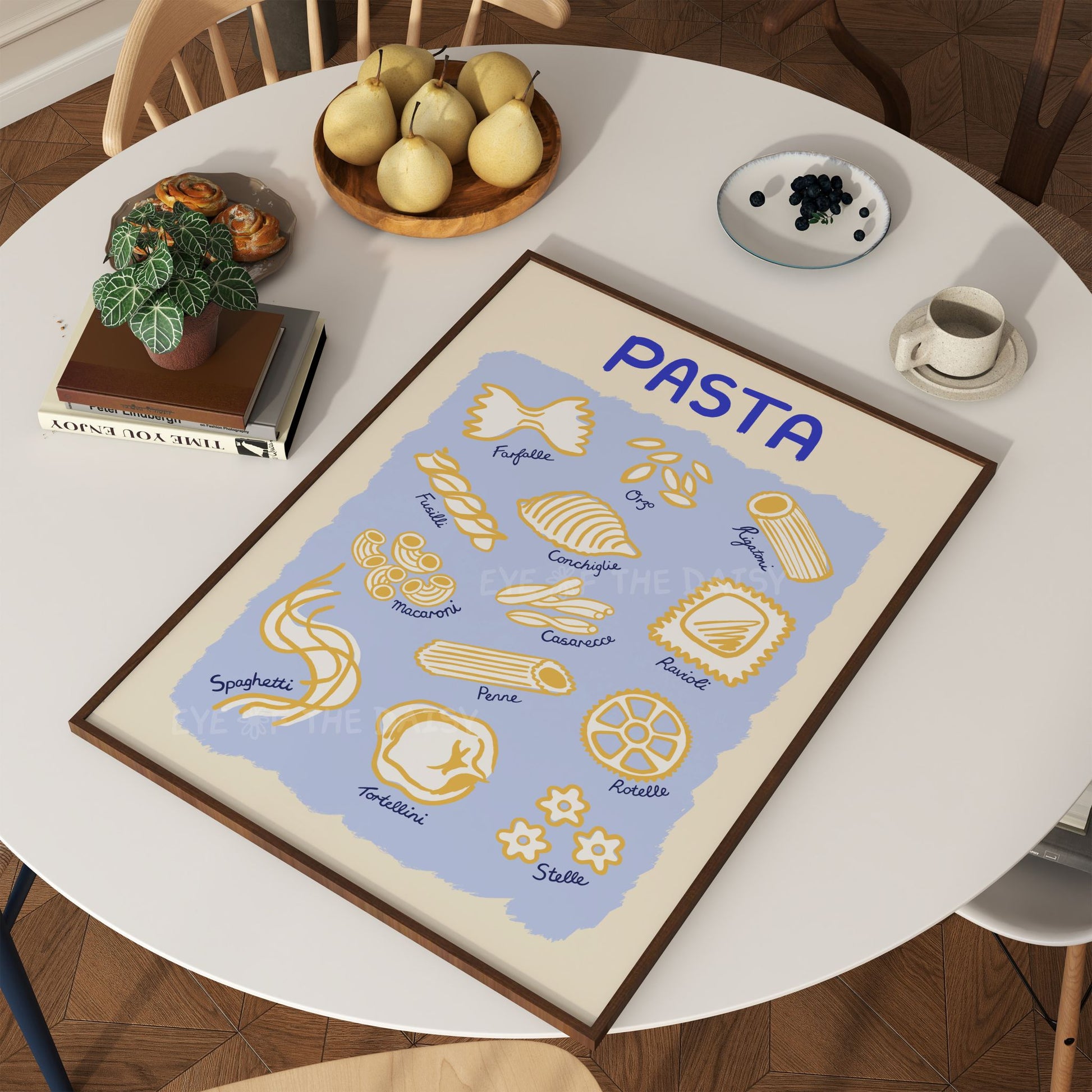 Modern hand drawn "Pasta Guide" wall art print with different pasta type illustrations displayed on a kitchen table