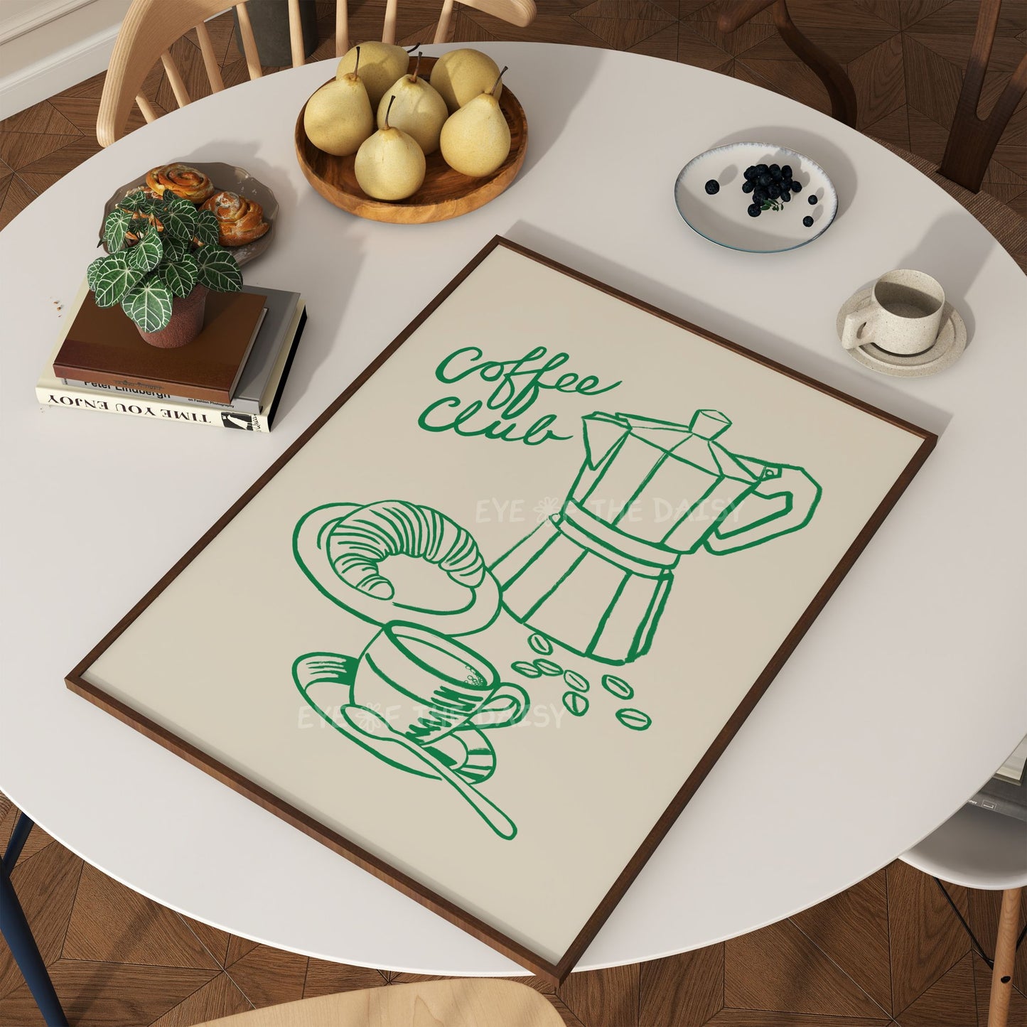 Trendy "Coffee Club" phrase print showing a green line drawing of a coffee Moka pot, a cup of coffee and a croissant on a kitchen table