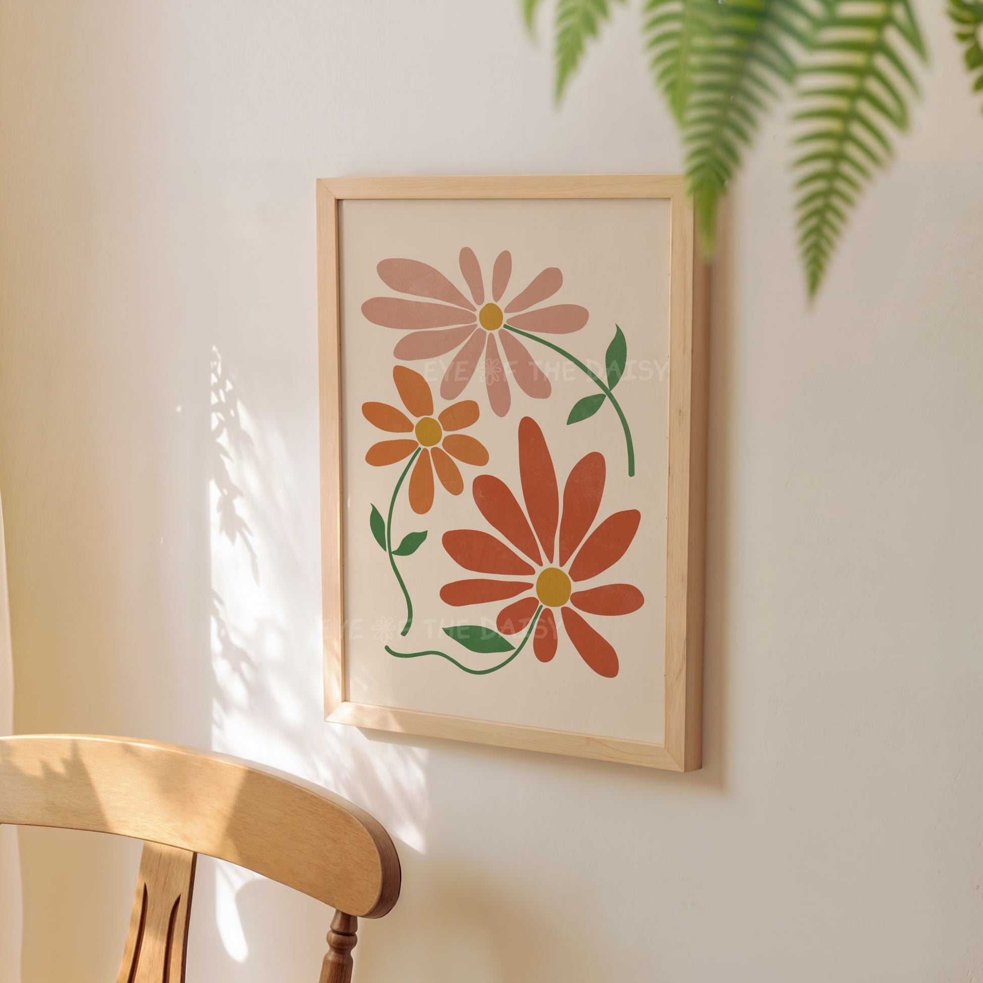 Wall art print of terracotta abstract flowers displayed on a wall in a wooden frame