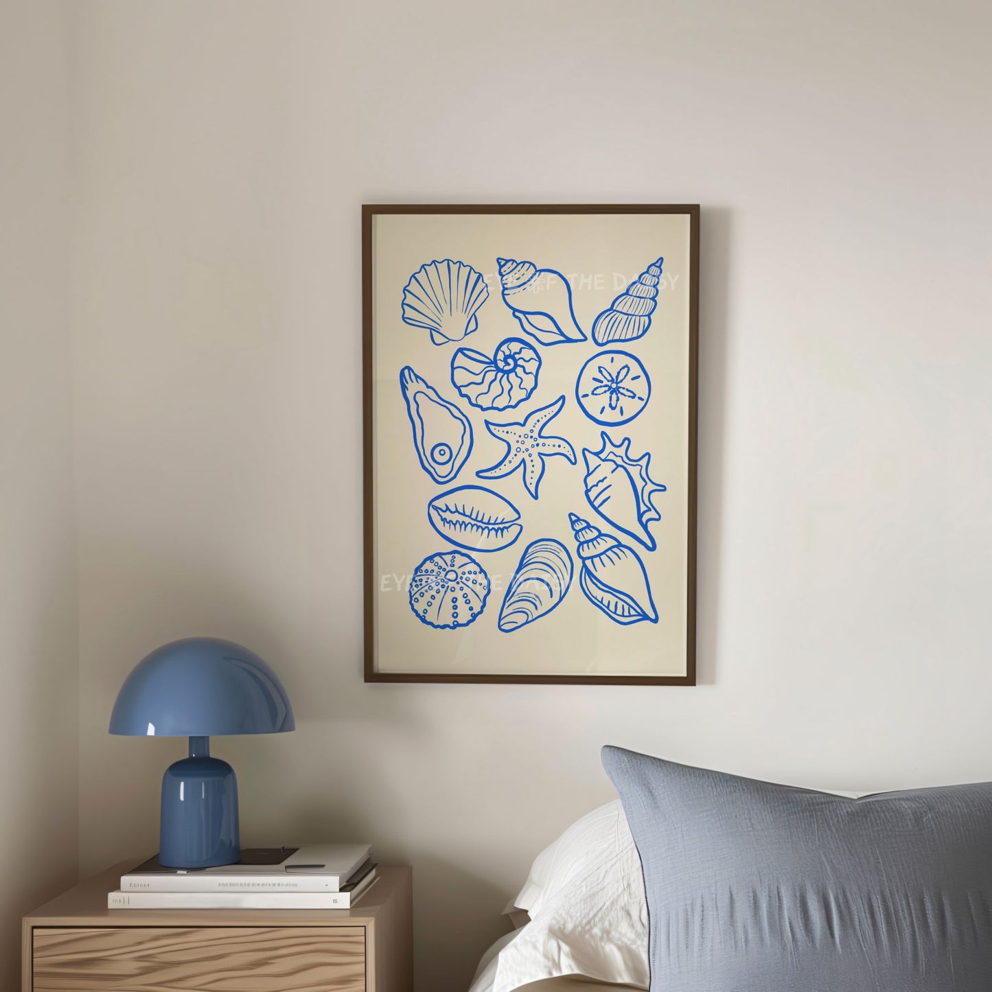 Contemporary blue Hamptons style shells wall art print displayed in a trendy coastal bedroom