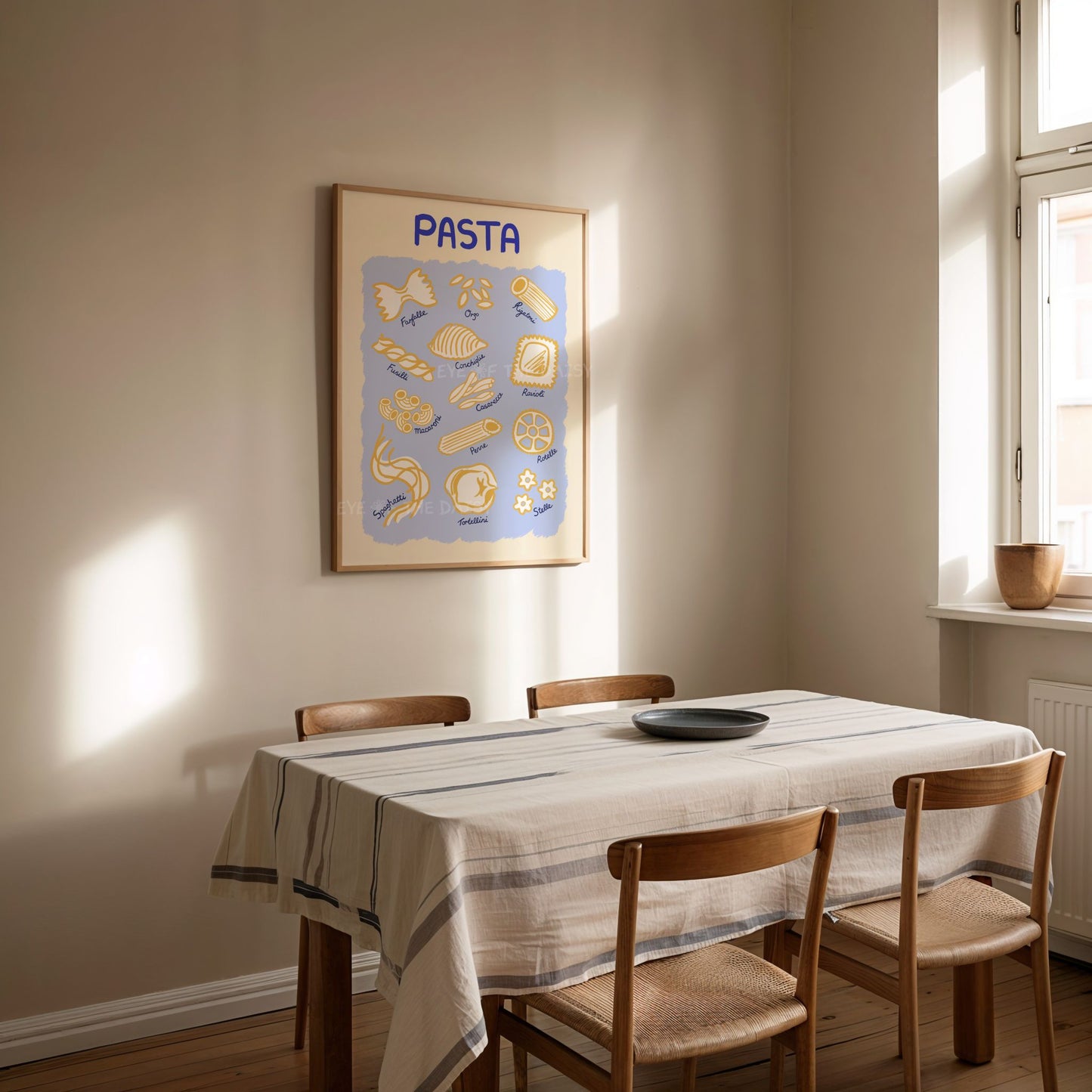 Dining room with a fun hand drawn pasta art print displayed on the wall in an Italian style dining room