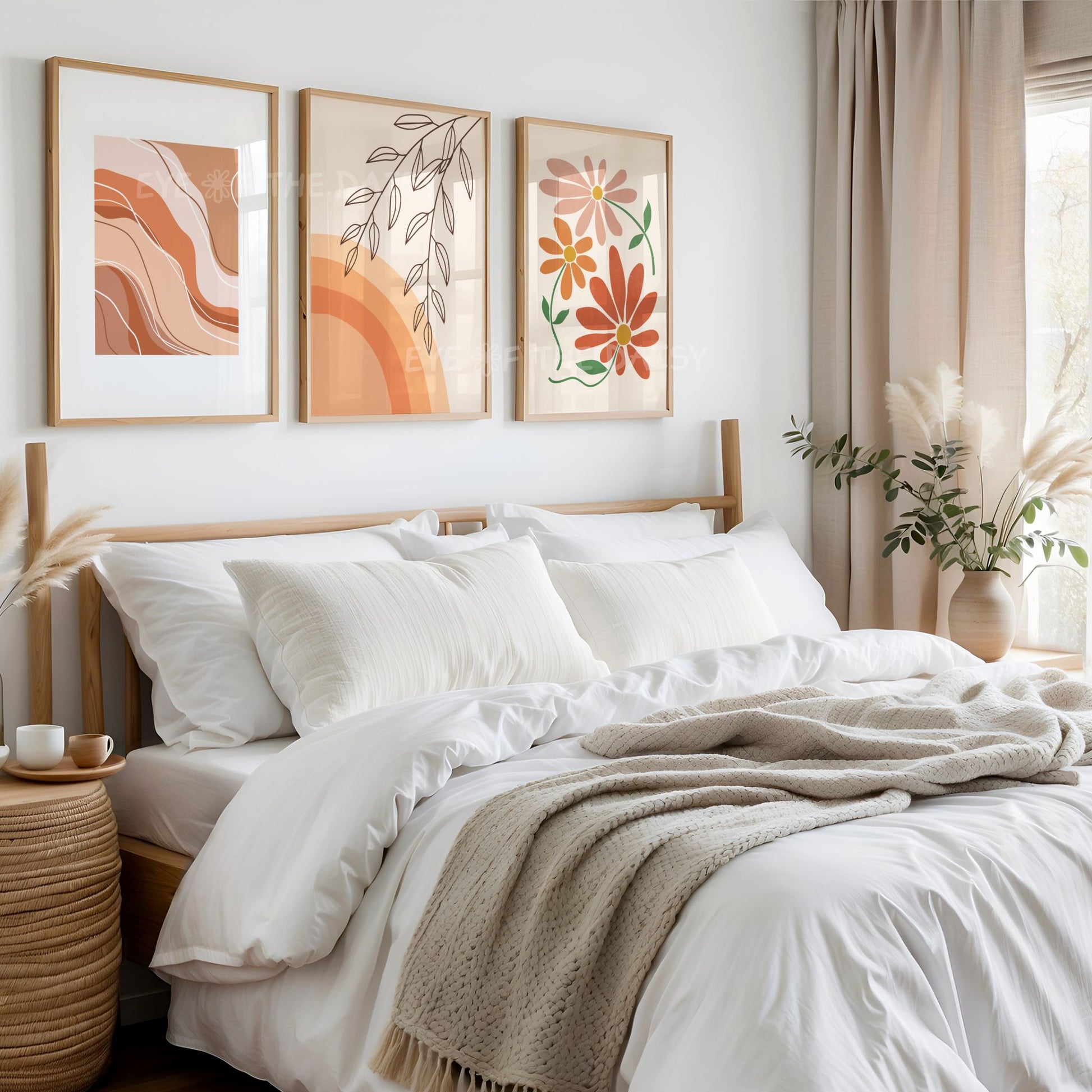 Triptych of three boho wall art prints with abstract botanical and wavy line designs on the wall of a neutral boho bedroom