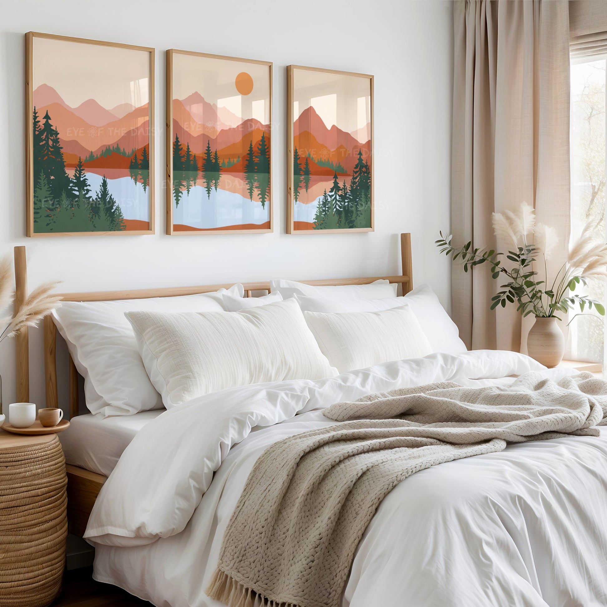 Set of 3 terracotta abstract landscape prints on the wall above a bed in a neutral beige bedroom 